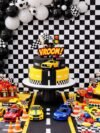 Car Theme Birthday Decoration Kit – 55-Piece black and white racing party set with balloons, bunting flags, happy birthday banner, 6x6 ft backdrop, and race road strip