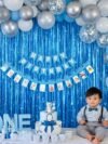 Baby First Birthday Blue Balloon Decoration – 12-month milestone photo banner set in royal blue, Newborn to Month 12 cards on rope display
