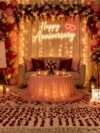 63 PCS Anniversary Decoration Combo Pack – wine, rose gold chrome & pink balloons with white net curtains and warm LED fairy lights for romantic anniversary setup
