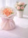 Peach Satin Ribbon Rose Bouquet – handcrafted decorative floral arrangement with ribbon roses and accent greenery for gifting and home décor