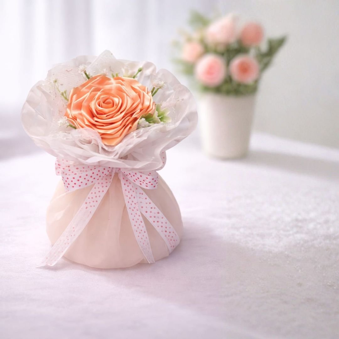 Peach Satin Ribbon Rose Bouquet – handcrafted decorative floral arrangement with ribbon roses and accent greenery for gifting and home décor